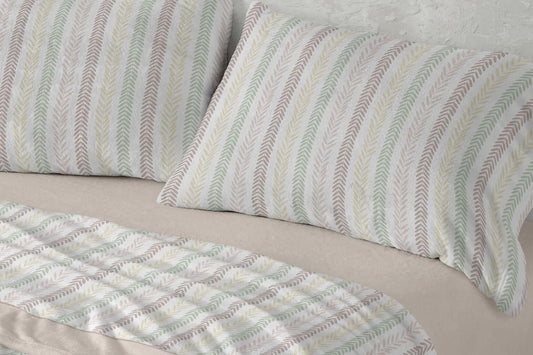 Detalle del tejido y estampado beige de las sábanas de coralina