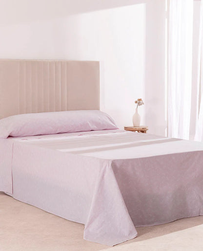 Juego de sábanas 100% algodón rosa en una cama